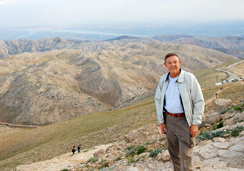Approach the top of Mount Nemrut with the Euphrates Valley below.