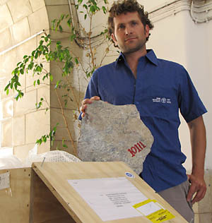 IAA_ShayBarTura_package-t Shay Bar Tura displays the package and the returned stone. Photo by IAA.