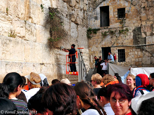 Women watch at the Western Wall while workmen remove snake from the wall. Photo by Ferrell Jenkins.