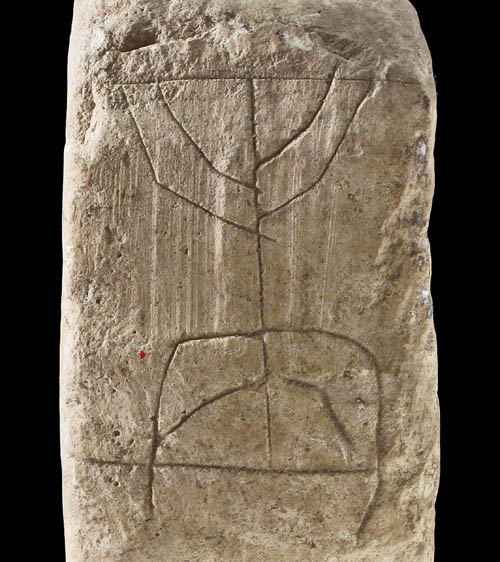 Menorah found beneath 1st century street. IAA photo by Vladimir Naykhin.