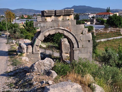Arch built by Vespasian partially below modern road level. Photo by Ferrell Jenkins.