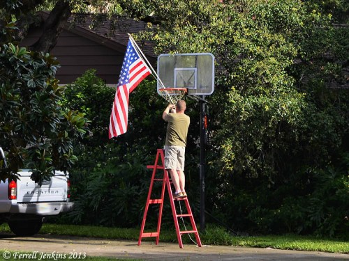 A veteran puts up his flag on July 4th. Photo by Ferrell Jenkins.