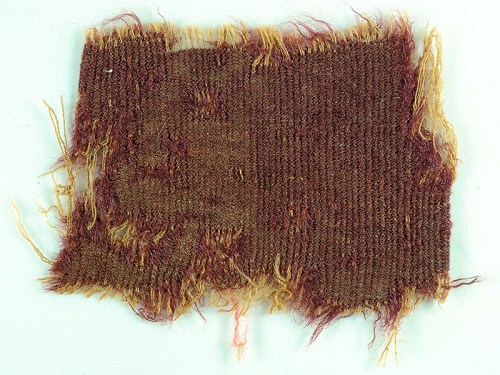 Purple fabric discovered at Wadi Murabba'at at caves south of Qumran. Photograph: Clara Amit, courtesy of the Israel Antiquities Authority.