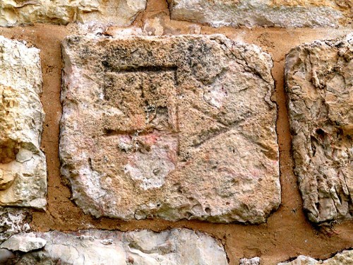 Partial stone bearing inscription of the Tenth Legion reused in the wall of the Old City near Jaffa Gate. Photo by Tom Powers.