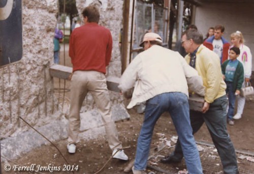 American tourist use a concrete post to dry to break through the Berlin Wall. Photo by Ferrell Jenkins.