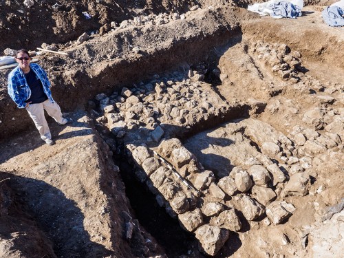 Excavation director Ronit Lupo of the Israel Antiquities Authority next to the remains of the ancient house. Photo credit: Assaf Peretz, courtesy of the Israel Antiquities Authority 