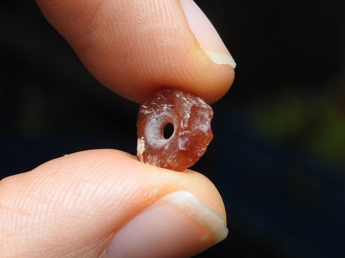 7,000-year-old bead. Photo credit: Ronit Lupo, courtesy of the Israel Antiquities Authority