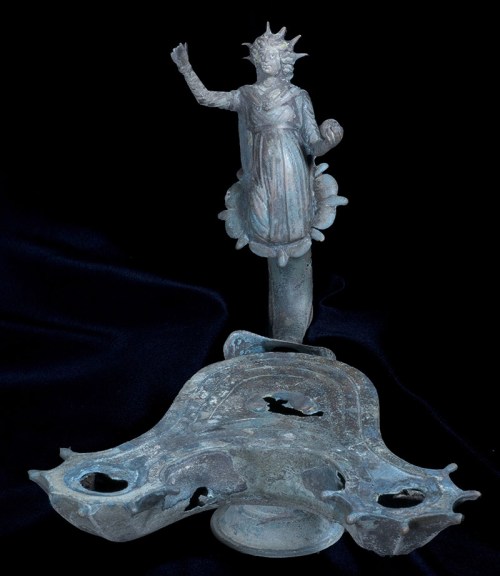 A bronze lamp decorated with the image of the sun god Sol. Photographic credit: Clara Amit, courtesy of the Israel Antiquities Authority.