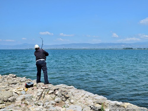 A fisherman stands on some of the ruins of the ancient imperial palace. Photo by Ferrell Jenkins.