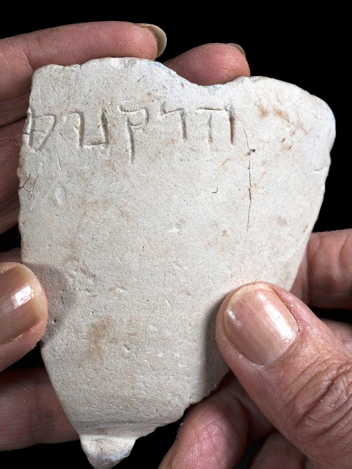 A fragment of the chalk bowl from the Hasmonean period, which is engraved with the name “Hyrcanus”. Photo credit: Clara Amit, Israel Antiquities Authority.
