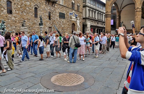 Tourists in Florence, Italy, seem to walk around the plaque marking the site where Savonarola was martyred. Photo by Ferrell Jenkins.