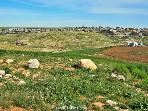 The green hill in the foreground is the ancient site of Dibon. The view is to the east. The modern town of Dhiban, Jordan, is in the distance. Photo by Ferrell Jenkins.