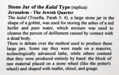 Sign explaning the large stone jars used for purification. Hecht Museum.