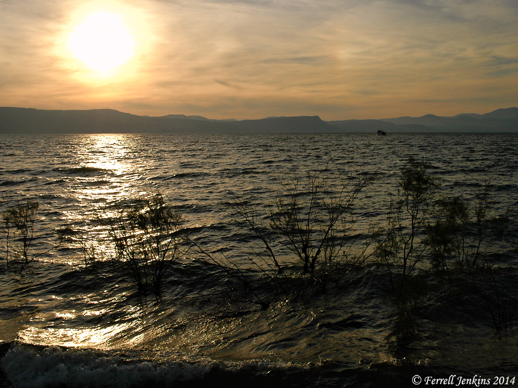 The Sea of Galilee from the east at sunset. The water is choppy. 